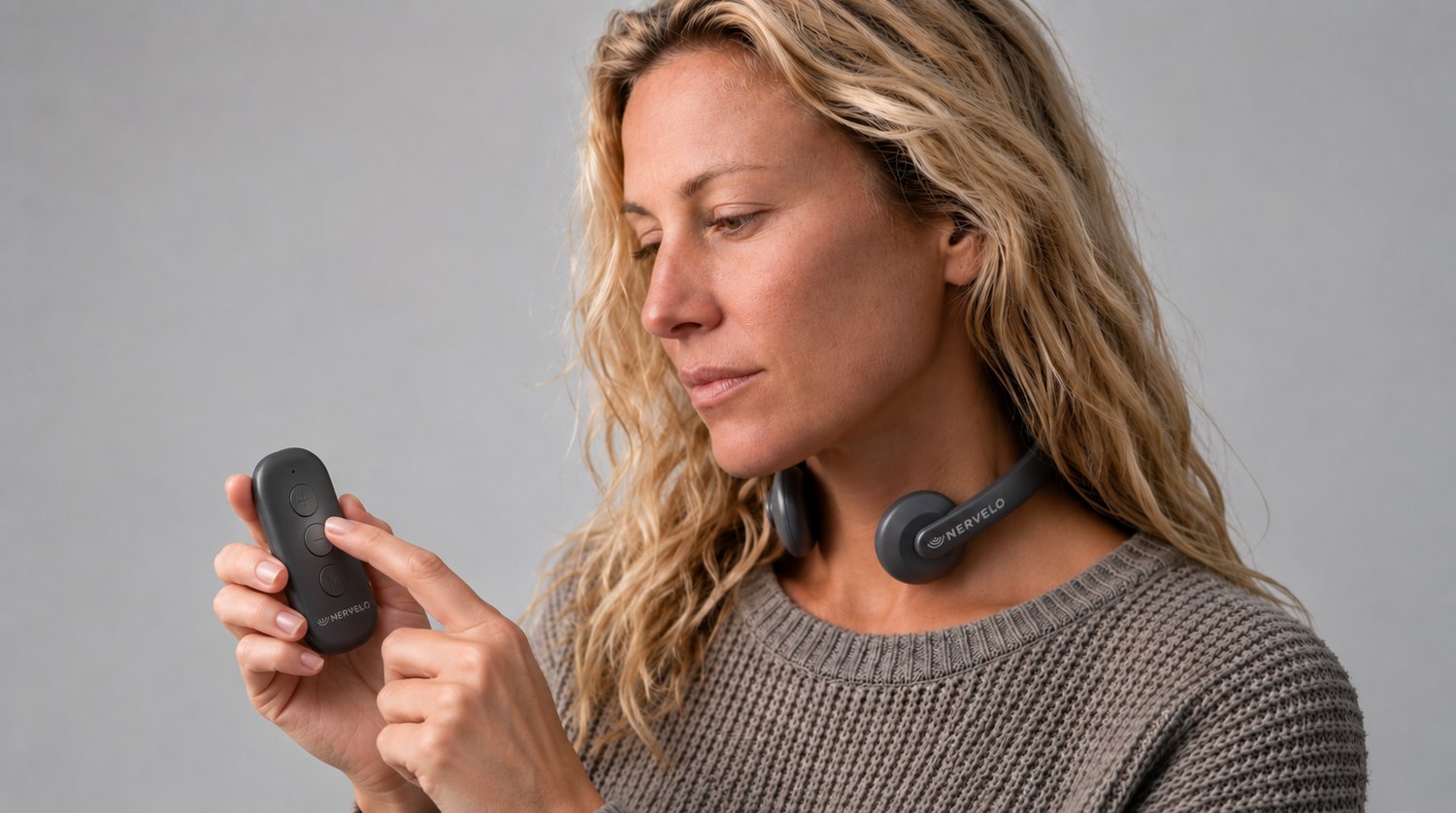 A woman wearing Nervelo and changing the mode with the remote